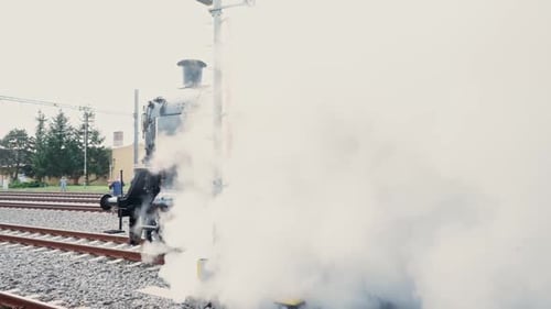 Powerful Steam Engine Emerging From A Thick Cloud Of Smoke