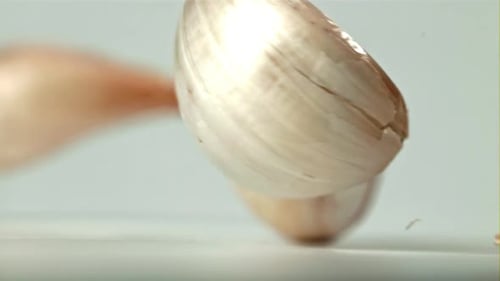 Fresh Garlic Falls on the Table Filmed on a Highspeed Camera at 1000 Fps