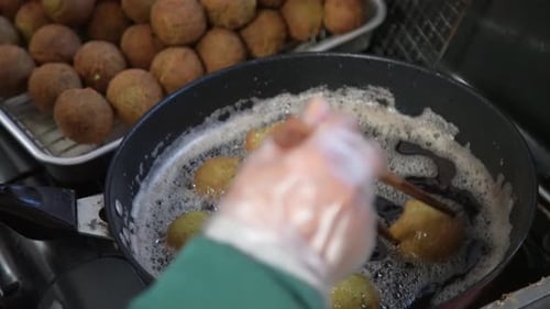 Falafel Balls Frying in Skillet with Oil