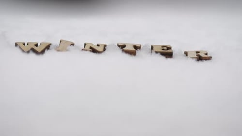Wooden Letters Spelling Winter on Snowy Surface