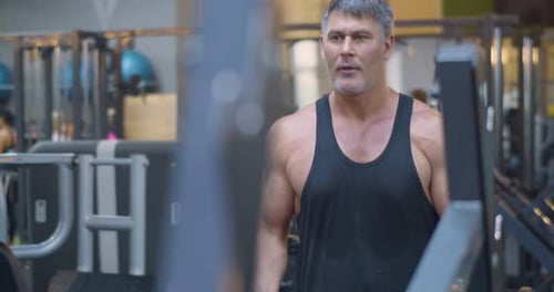Gym Workout Bicep Exercise Middle Aged Caucasian Man Trains His Bicep Muscles in the Gym