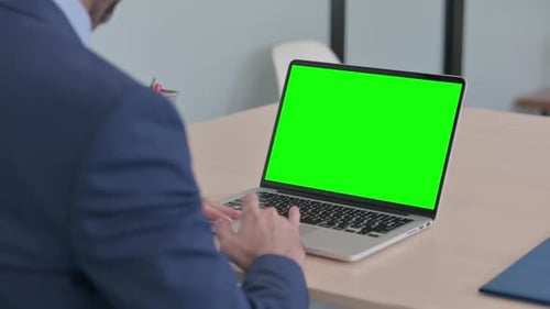 Businessman Using Laptop with Green Screen