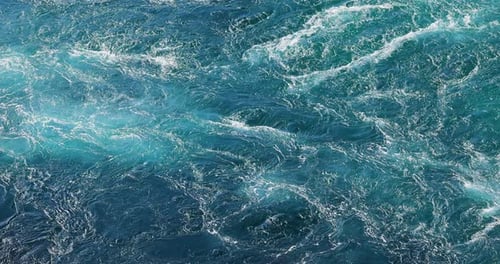 Blue waves of water of the river and the sea meet each other during high tide and low tide.