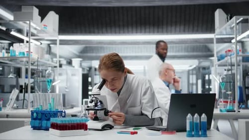 Scientist Using Microscope in Modern Bright Laboratory