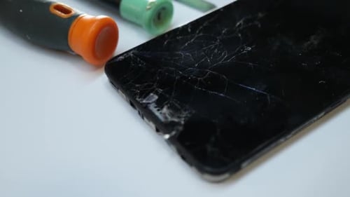 Damaged Smartphone with Shattered Screen Close Up