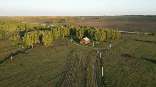 Aerial View of Countryside Landscape in Harvesting Season Harvested Crop Field Farmhouse From Above