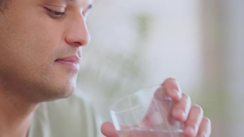 Adult Swallowing Pill and Drinking Water Indoors