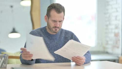 Man Reviewing Documents in an Office