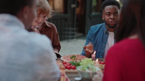 Friends Sharing a Meal at a Countryside House in the Woods