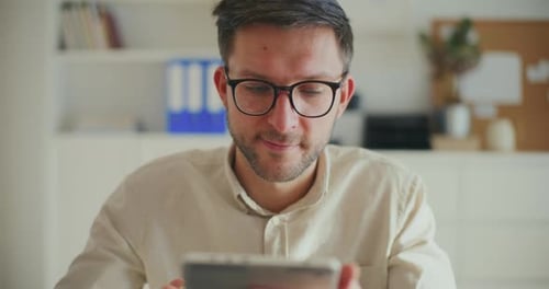 Pensive Contemplative Businessman Working on Digital Tablet At Office