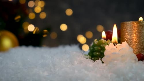 Decorative Christmas Candles in Snow Close Up