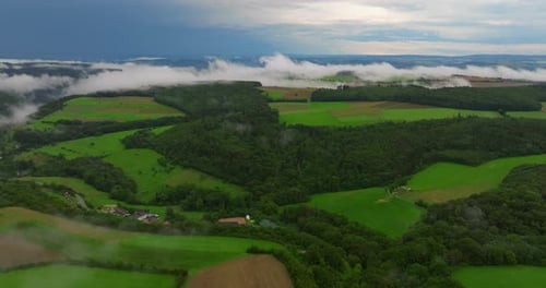 Drone Flight Over Clouds and Green Fresh Forest in Hilly Europe Germany Aerial View Around the Foggy