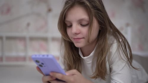 Young Subject Using Cell Phone on Bed Indoors
