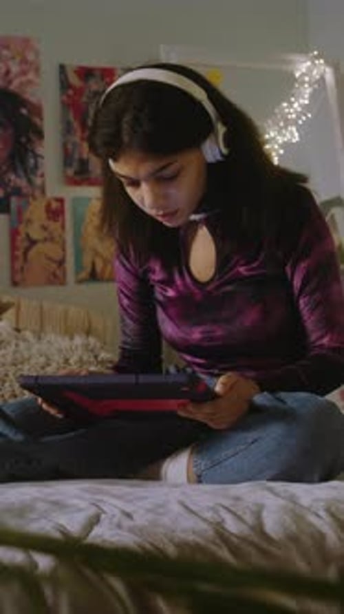 Beautiful African American Girl Surfs Internet Using Tablet