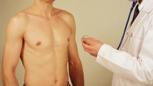 Doctor Examining Patient with Stethoscope During Clinical Visit