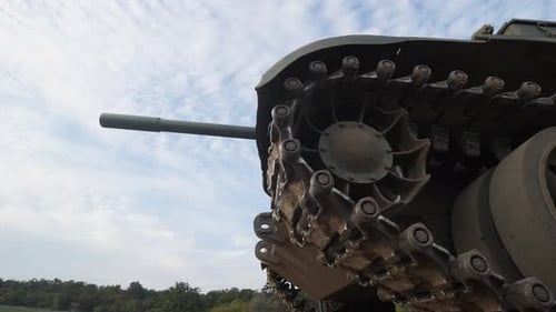 Vintage Tank on Grassy Field Under Cloudy Sky