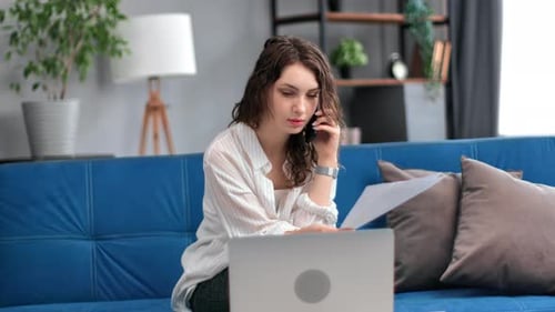 Young Woman Working at Home on Couch