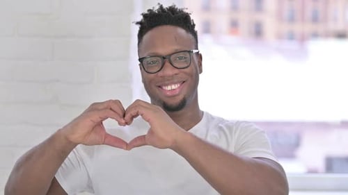 Young Adult Smiling Making Heart With Hands