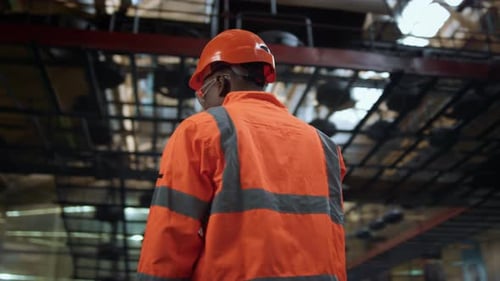 Cheerful Supervisor Looking Camera At Modern Huge Industrial Facility Warehouse. Joyful Man Speci...