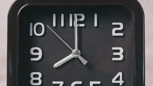 The Pointer Clock of Square Shape on Wooden Table Shows Time 8 Hours