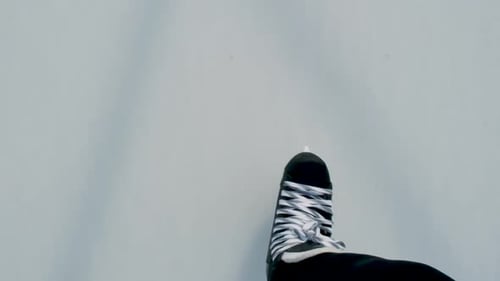 Slow-Motion point of view of hockey skates crossing on ice