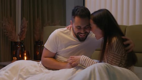Happy Boyfriend Girlfriend Couple Husband Wife Man Woman Together on Bed Playing Playful Laughing