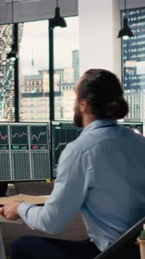 Vertical Video Traders in Office Follow Breaking News TV Coverage of Rare Black Swan Event