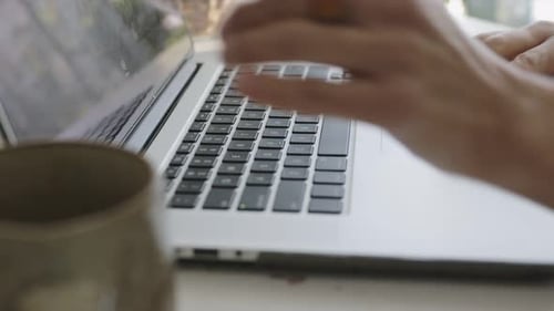 Woman's Hands Typing on Laptop Keyboard Close Up