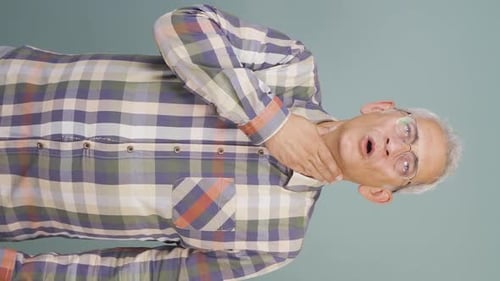 Adult Man Holding Sore Throat in Mid Shot