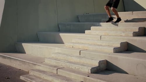 Man Running Down Concrete Steps in Urban Setting