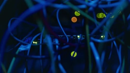 Computer Cables and Ethernet Ports in Dark Server Room