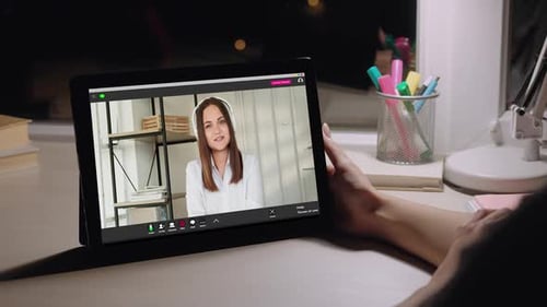 Woman on Video Call Using Tablet at Night