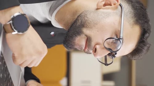 Man With Glasses Typing At Computer In Office