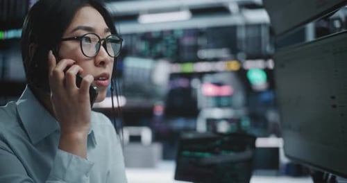 Anxious Female Trader Talking on Smartphone During Stock Market Crash in Digital Office
