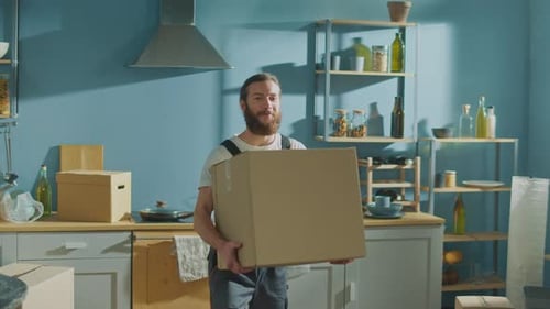 Workers of Moving Company With Uniforms Carefully Carrying Boxes