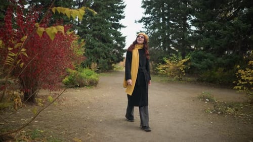 Beautiful Lady Walking Through Vibrant Garden Wearing Yellow Beret and Scarf Looking Around
