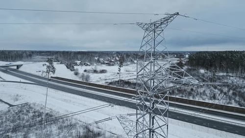 An Aerial View Capturing a Beautiful Winter Landscape Featuring a Snowy Highway Intertwined with