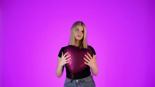 Blonde Young Caucasian Female Model Holds a Heart Shaped Balloon in Love Studio Infinite Violet Back
