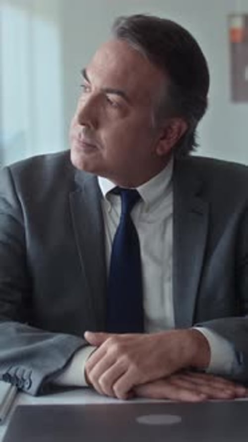 Senior Pensive Entrepreneur Suffering from Headache Working in Office