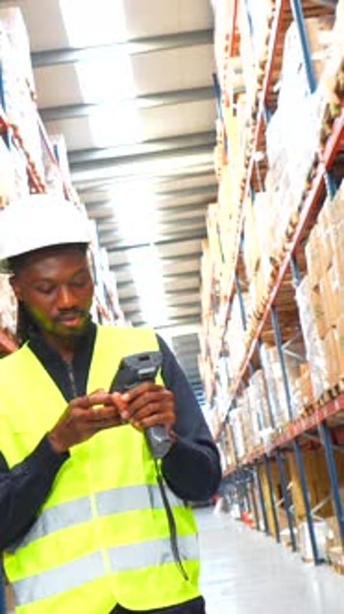 Warehouse Worker Scanning and Checking Inventory with Barcode Scanner
