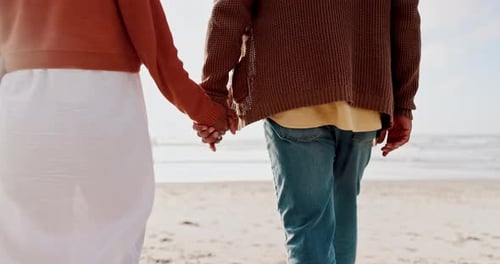 Back, holding hands and a couple walking on the beach together at sunset for romance in summer
