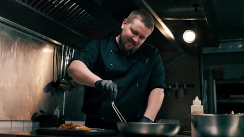 in a Professional Kitchen the Chef Puts Readymade Chicken Wings on Wooden Tray