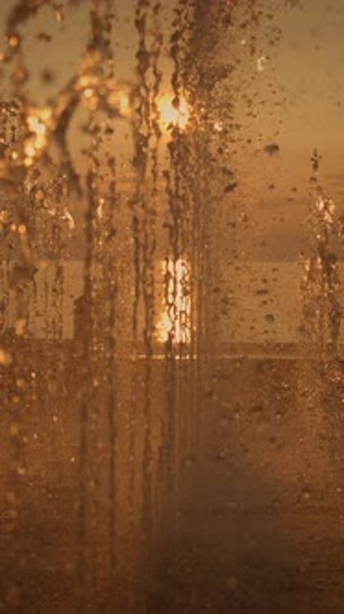 Water Fountain with Golden Sunset in Background