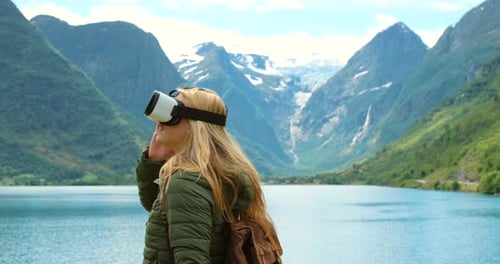 Woman Using VR Goggles in Mountain Scenery
