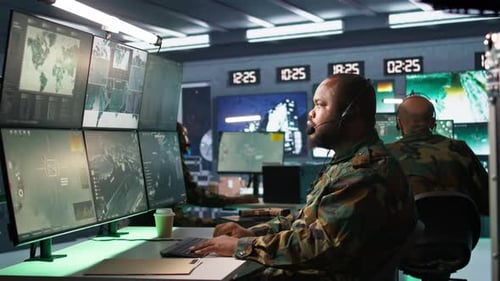 Military Dispatcher Managing Communications Networks Looking at Screens