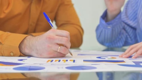 Close up of Hands Working on Business Report, Documents