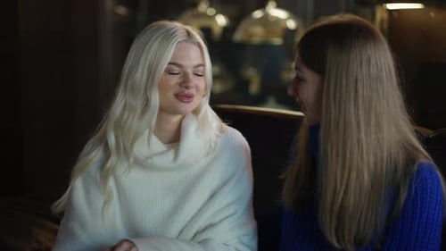 Two Women on Sofa are Hugging and Supporting Each Other at the Cafe