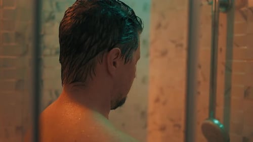 Stressed Man Taking Shower in Bathroom