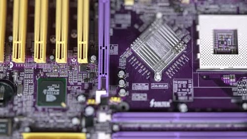 Closeup Of The Motherboard Microchips And Connectors On The Integrated Circuit.