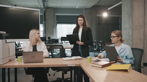Team members discuss projects in a bright office space during a work meeting in the city
